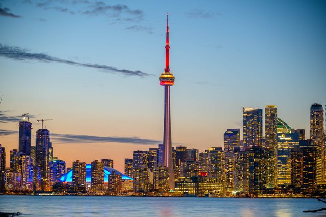 Toronto skyline with the CN Tower reflected in the lake at sunset